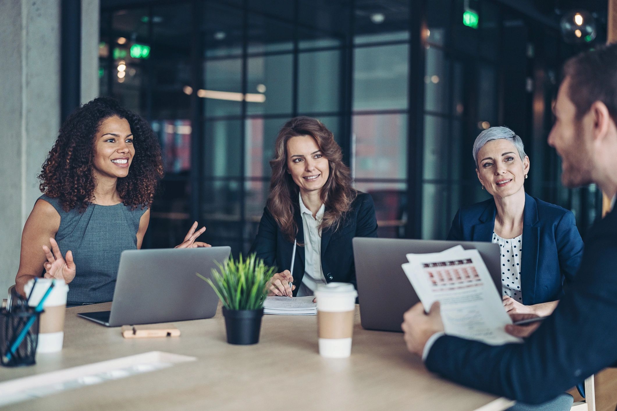Senior software team collaborating in a modern meeting room