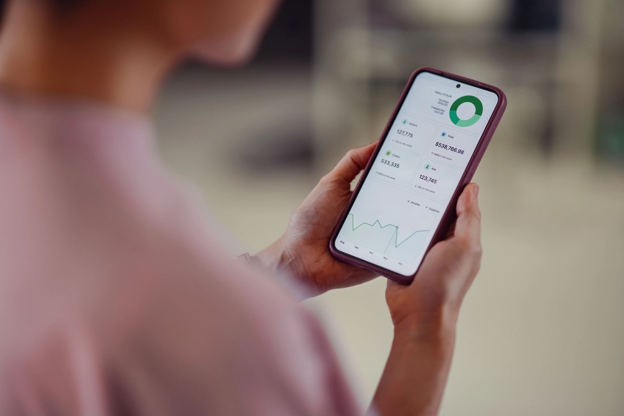 Person using a smartphone financial app representing fintech stakeholders