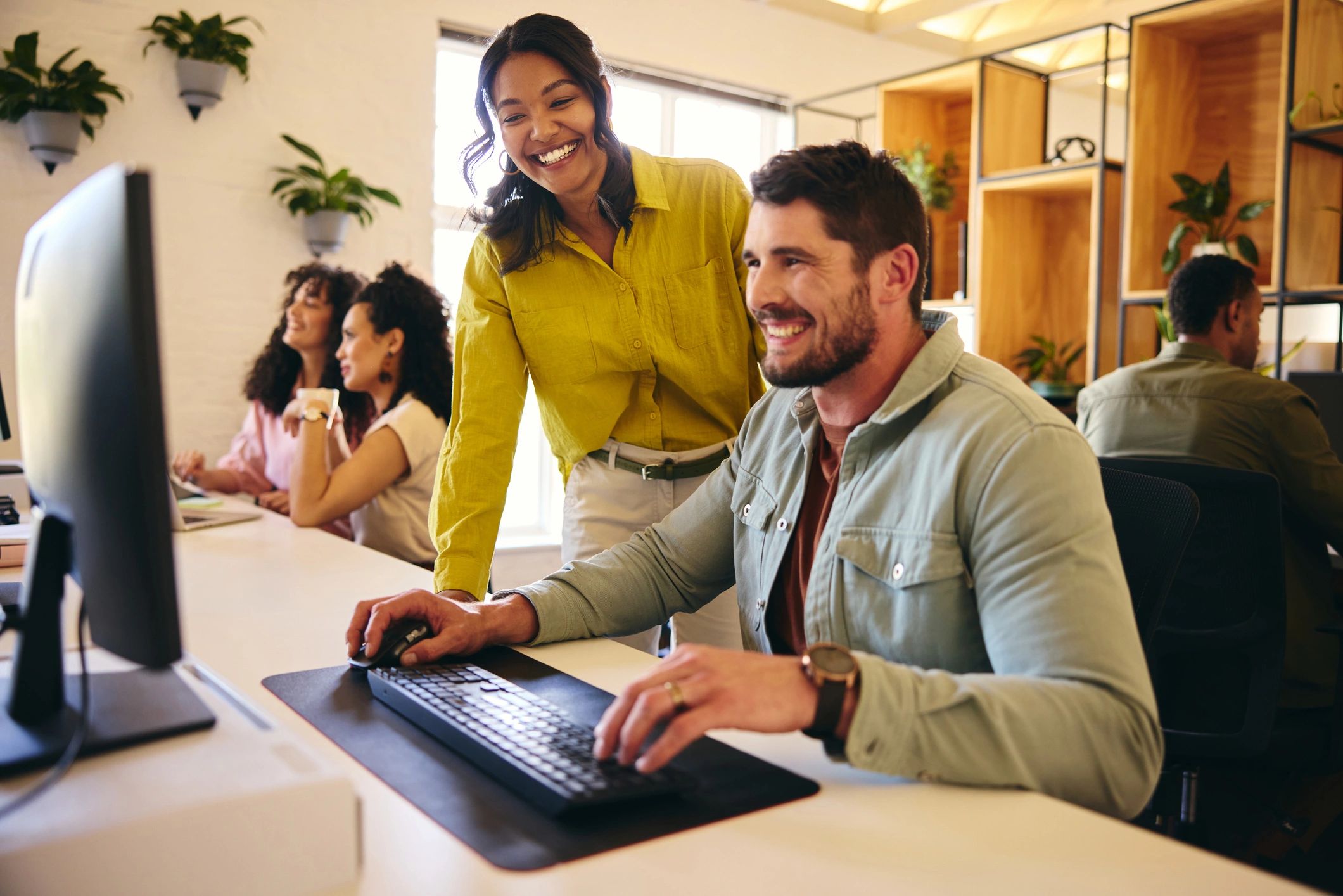 Software engineers collaborating at a desktop workstation