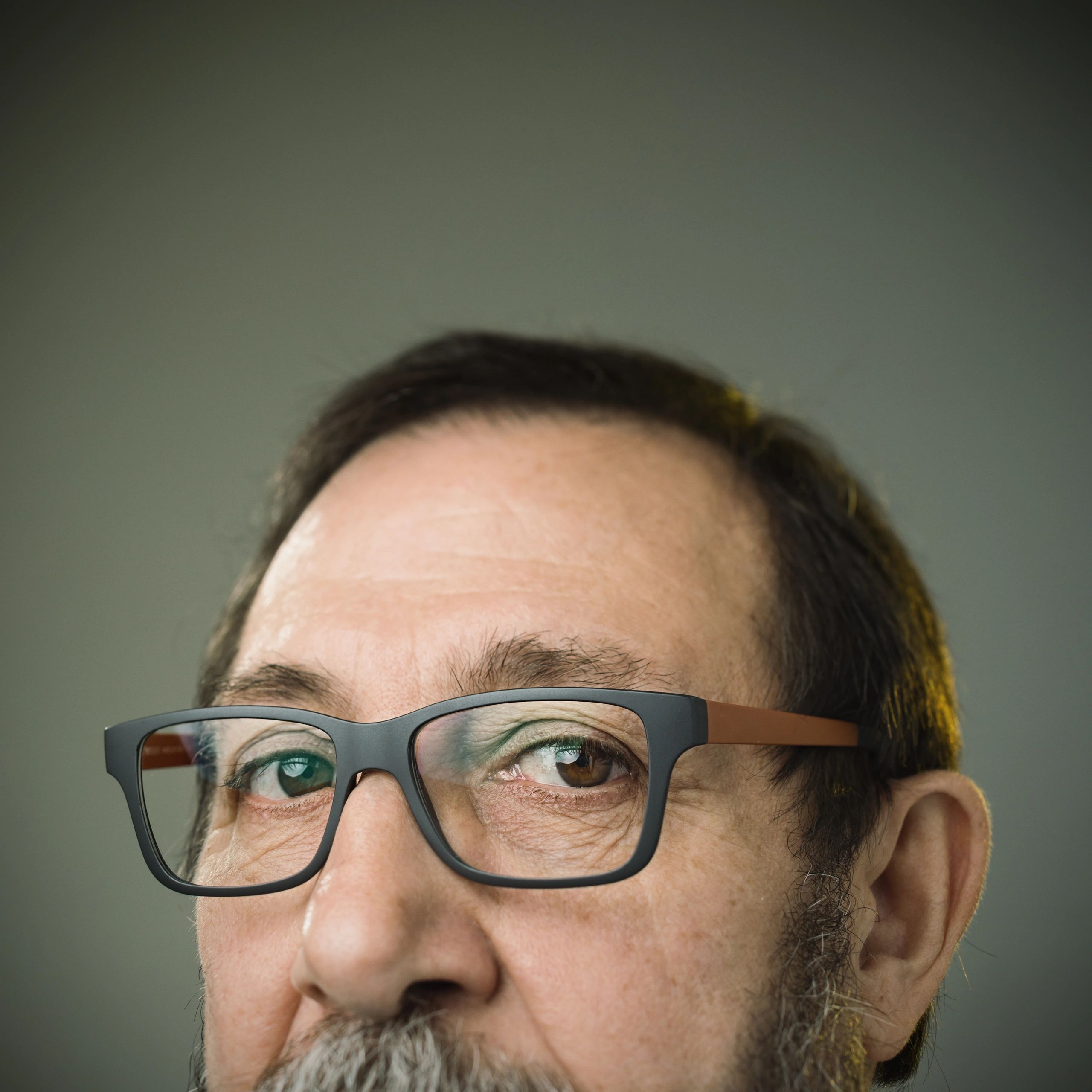 Professional headshot of a client representative with glasses